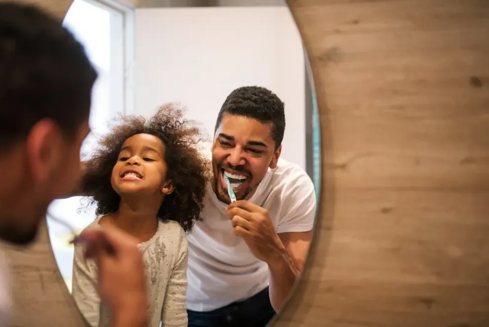 child-and-father-brushing-teeth