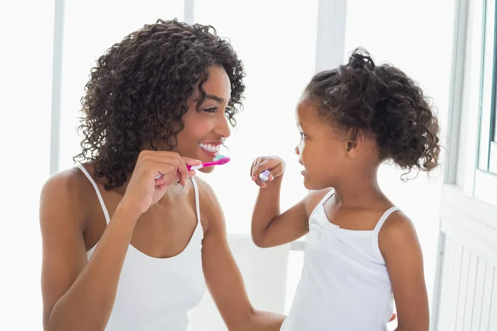 mom-and-daughter-brushing-teeth